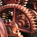 Small image of the inside of a clock, focusing on the gears.
